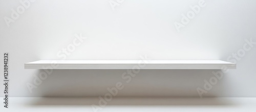 Minimalist white shelf against a blank wall showcasing clean lines and simplicity with ample Copy Space for text or graphics