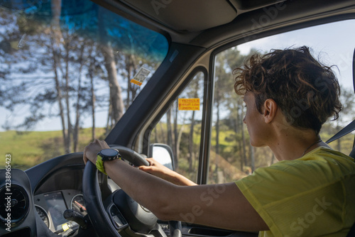 Woman driving modern van through green new zealand countryside