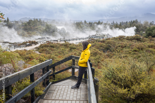 Tourist watching geothermal activity at kuirau park in rotorua, new zealand