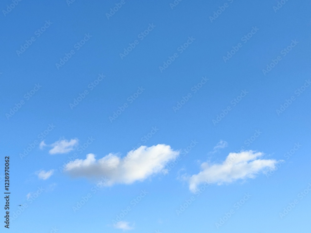 Full frame of pretty blue sky with unusual scudding cloud formation Full frame of pretty blue sky with unusual scudding cloud formation