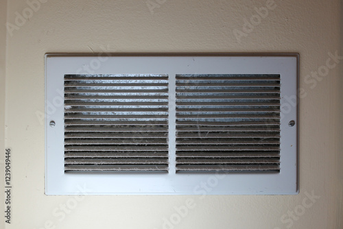 фотографія close-up of dusty louvered air white return air grille vent cover powder coated