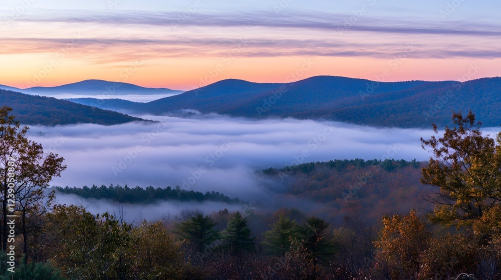 Fototapeta premium Serene landscape at dawn, tranquil mist hovering over valley, vibrant colors in sky, perfect for peaceful reflection.