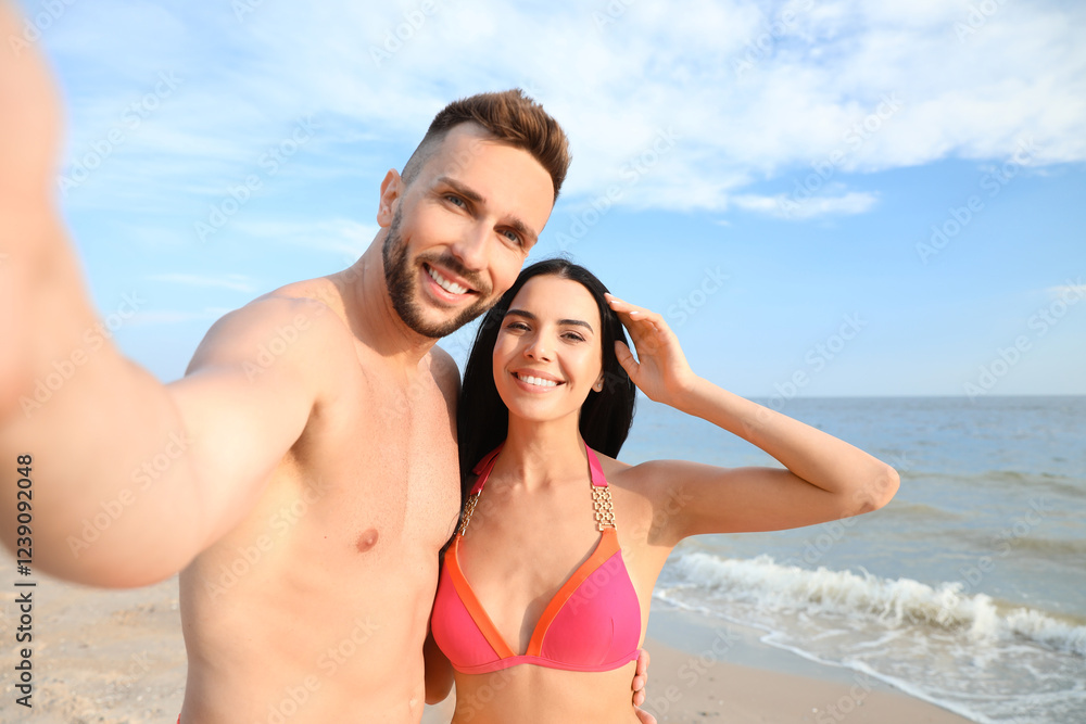 Happy young couple taking selfie on beach Happy young couple taking selfie on beach