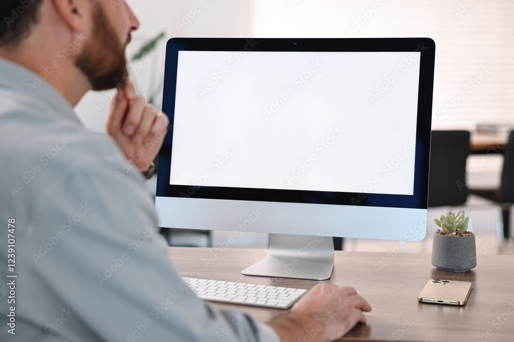 Man working on computer at table in office, closeup Man working on computer at table in office, closeup