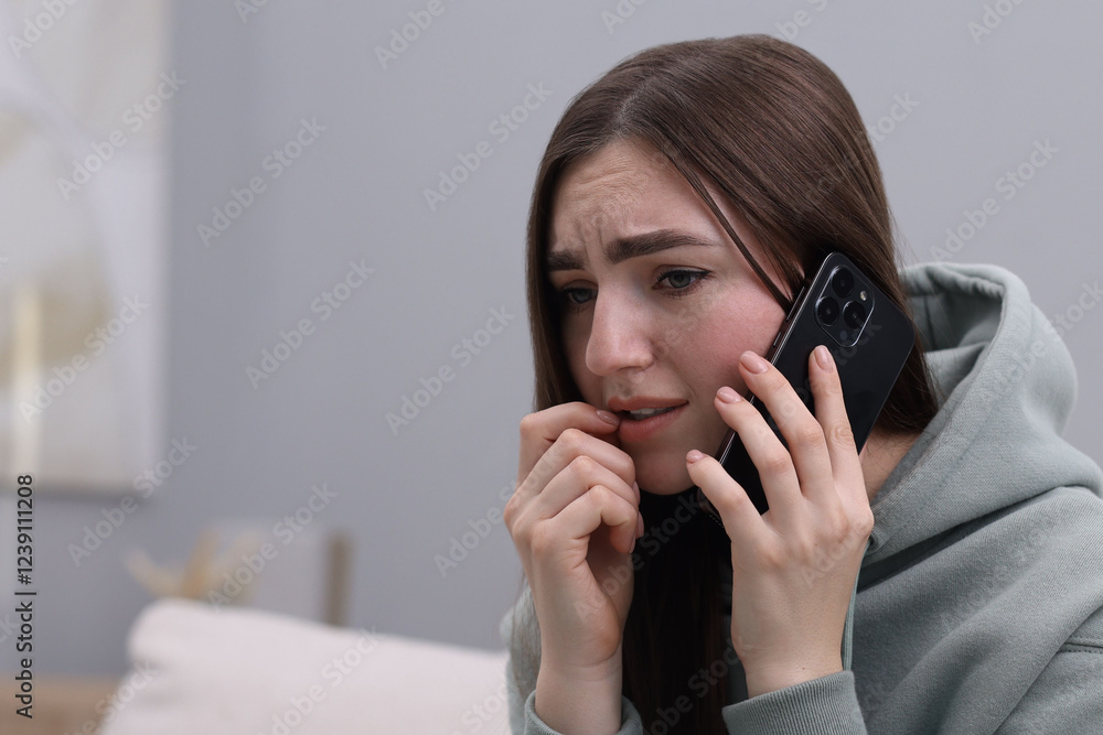 Stressed woman calling hotline for mental health help at home. Space for text Stressed woman calling hotline for mental health help at home. Space for text