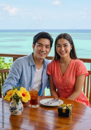 Happy Couple Smiles During a Romantic Date at Seaside Restaurant with a Beach View photo