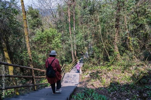 chongqing.china 24.03.2024 Tourists walking along a scenic nature trail at the breathtaking Three Natural Bridges in Wulong Karst National Geopark, Wulong City, China.