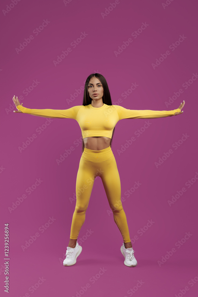 Fit young brunette woman doing functional exercises over purple background. Power and motivation concept. Fit young brunette woman doing functional exercises over purple background. Power and motivation concept.