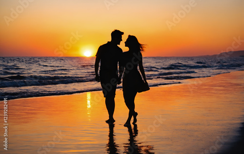Silhouette of romantic loving couple on beach at sunset