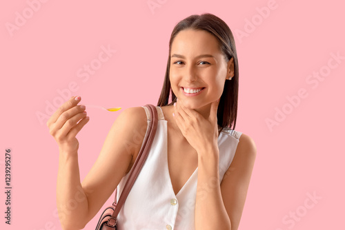 Young woman with syrup for ...