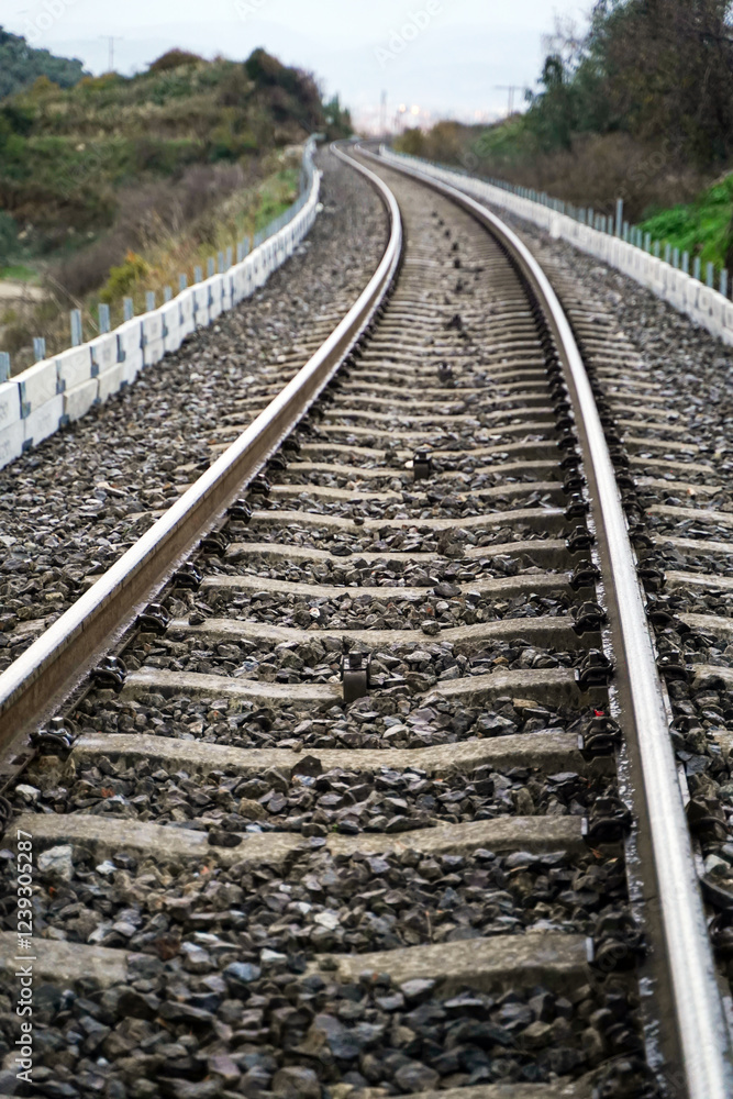 Cinematic View of a Train Track Stretching Towards the Horizon, Blurring into the Hazy Distance, Vertical Cinematic View of a Train Track Stretching Towards the Horizon, Blurring into the Hazy Distance, Vertical
