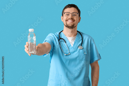 Male doctor with bottle of ...
