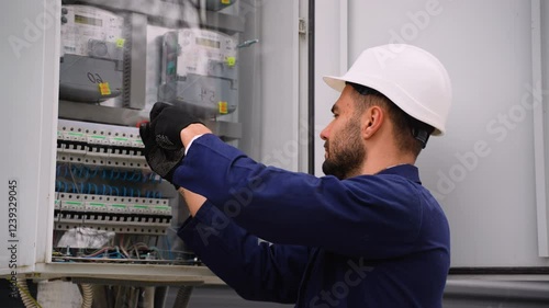 Electrician fixing electrical panel wiring outdoors