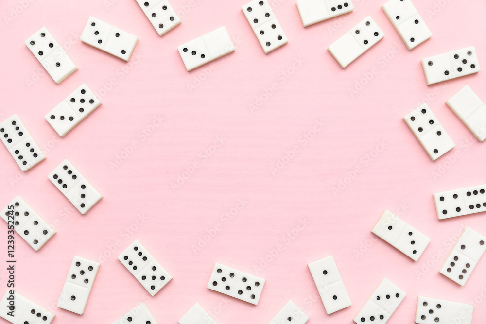 Frame made of white dominos blocks on pink background Frame made of white dominos blocks on pink background