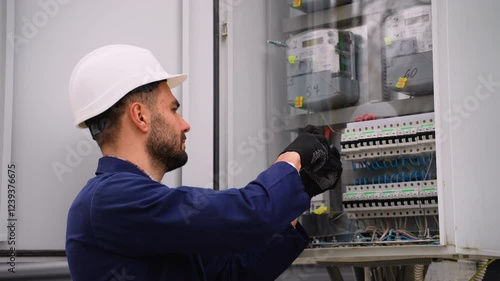 Electrician working on electrical panel wiring