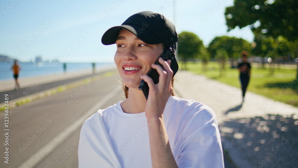 Cheerful woman speaking smartphone walking path near green sunny park closeup. Cheerful woman speaking smartphone walking path near green sunny park closeup.