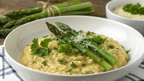 Creamy asparagus risotto garnished with fresh parsley, elegantly presented on a white plate photo