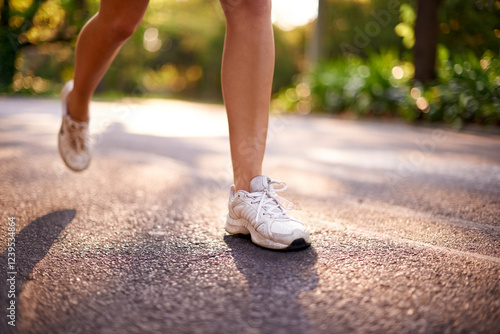 Running, legs and health with woman in road for marathon practice, workout and cardio. Wellness, exercise and sports training with closeup of person in nature for race, energy and athlete progress