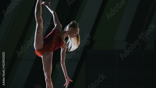 Rhythmic gymnast girl training in the gym.