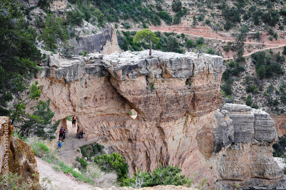 Tourists explore natural arch and rock formation in Grand Canyon National Park Tourists explore natural arch and rock formation in Grand Canyon National Park