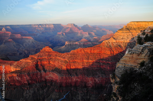 Grand Canyon's red and orange cliffs under a sunlit sky