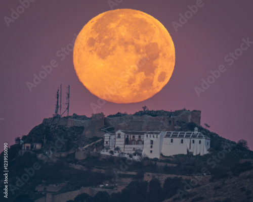 Sunset of the Moon over the castle of Archidona. Malaga. Spain.