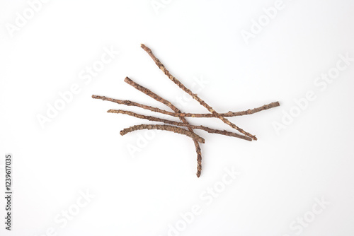 Photography close up of twigs lying on a plain white background