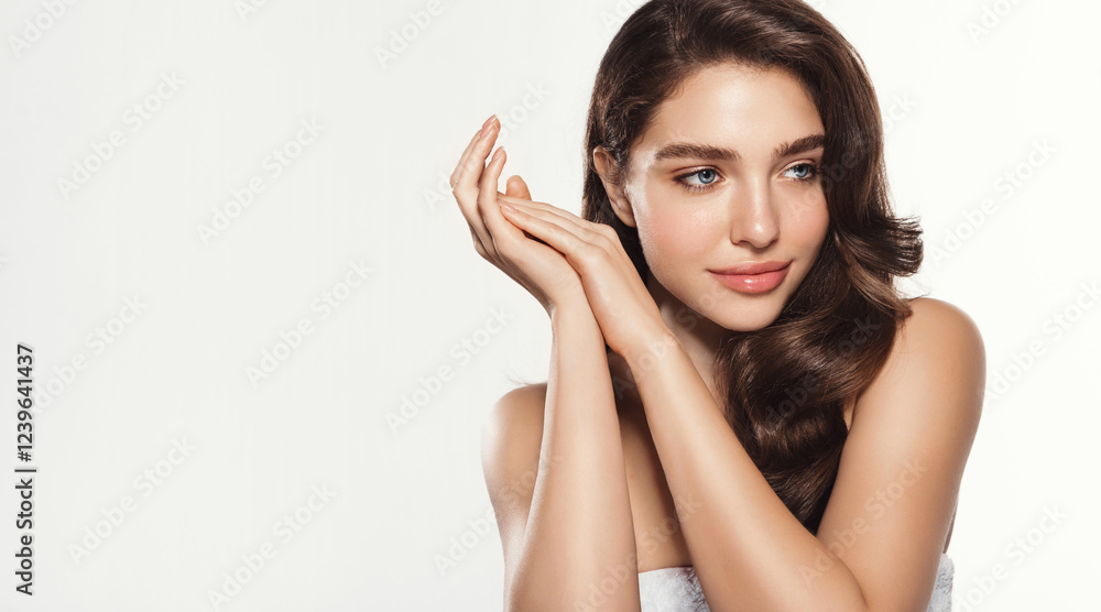 Portrait of elegant woman with curly hair, glowing radiant skin without blemishes, natural facial tone with healthy glow and vibrant expression, looking aside, standing over white studio background Portrait of elegant woman with curly hair, glowing radiant skin without blemishes, natural facial tone with healthy glow and vibrant expression, looking aside, standing over white studio background