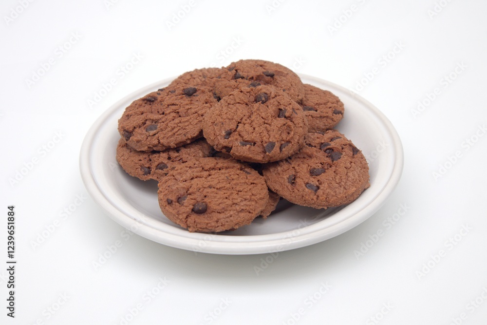 A pile of chocolate biscuits served on a white plate A pile of chocolate biscuits served on a white plate