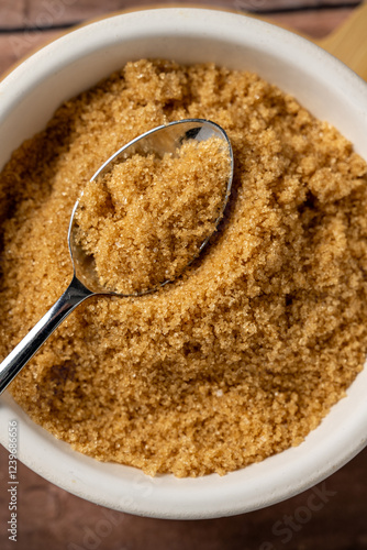 Closeup light brown granulated sugar in a bowl.  photo