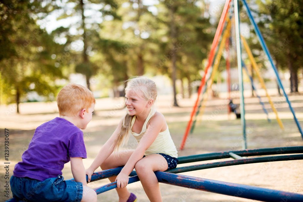 Obraz premium Happy, children and play on merry go round at park for summer fun, obstacle course and bonding together. Kids, ride and playground equipment with fine motor skills, active entertainment and childhood