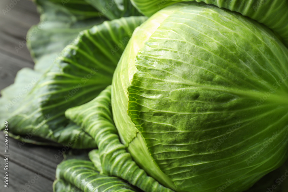 One ripe head of cabbage on black wooden table, closeup One ripe head of cabbage on black wooden table, closeup
