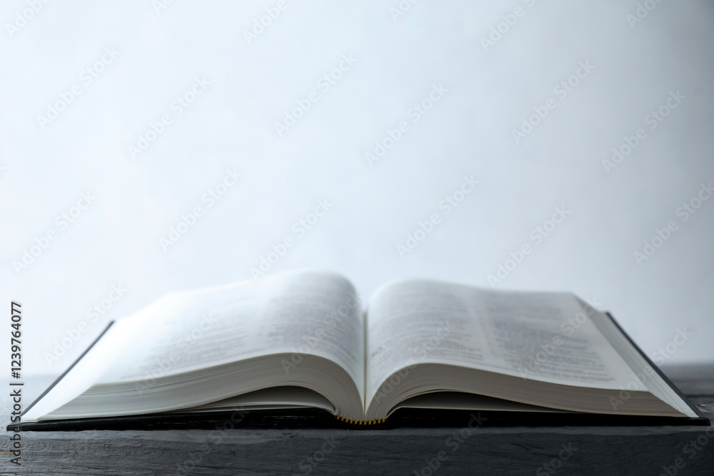 Open Holy Bible in English language on wooden table. Space for text Open Holy Bible in English language on wooden table. Space for text