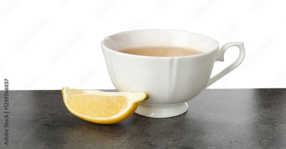 Refreshing green tea in cup and slice of lemon on grey textured table against white background Refreshing green tea in cup and slice of lemon on grey textured table against white background