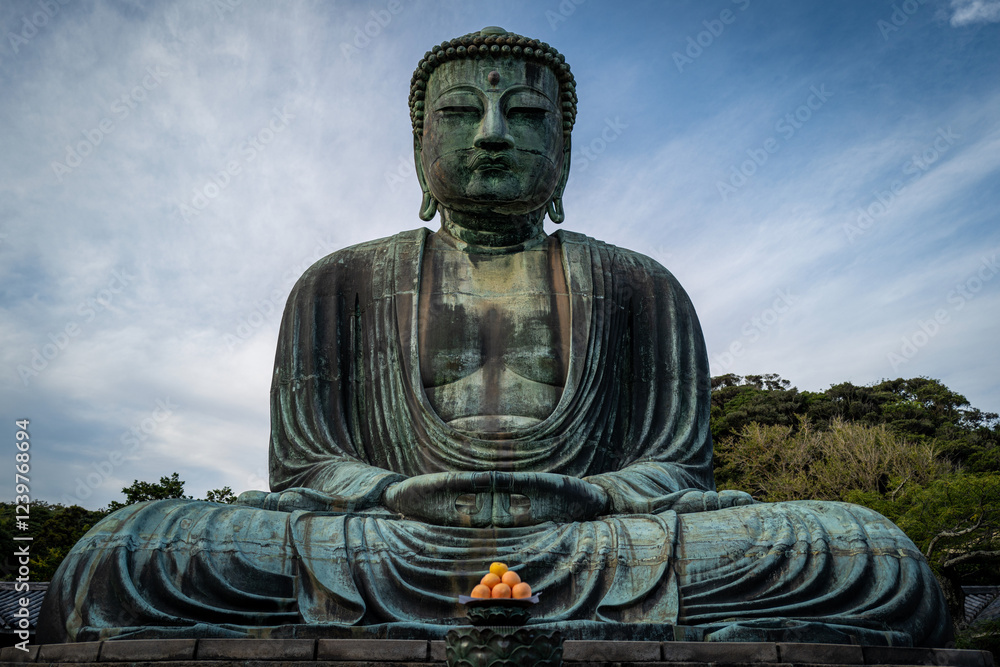 The Great Buddha of Kamakura sits peacefully under a partly cloudy sky, embodying serenity and spiritual contemplation. The Great Buddha of Kamakura sits peacefully under a partly cloudy sky, embodying serenity and spiritual contemplation.