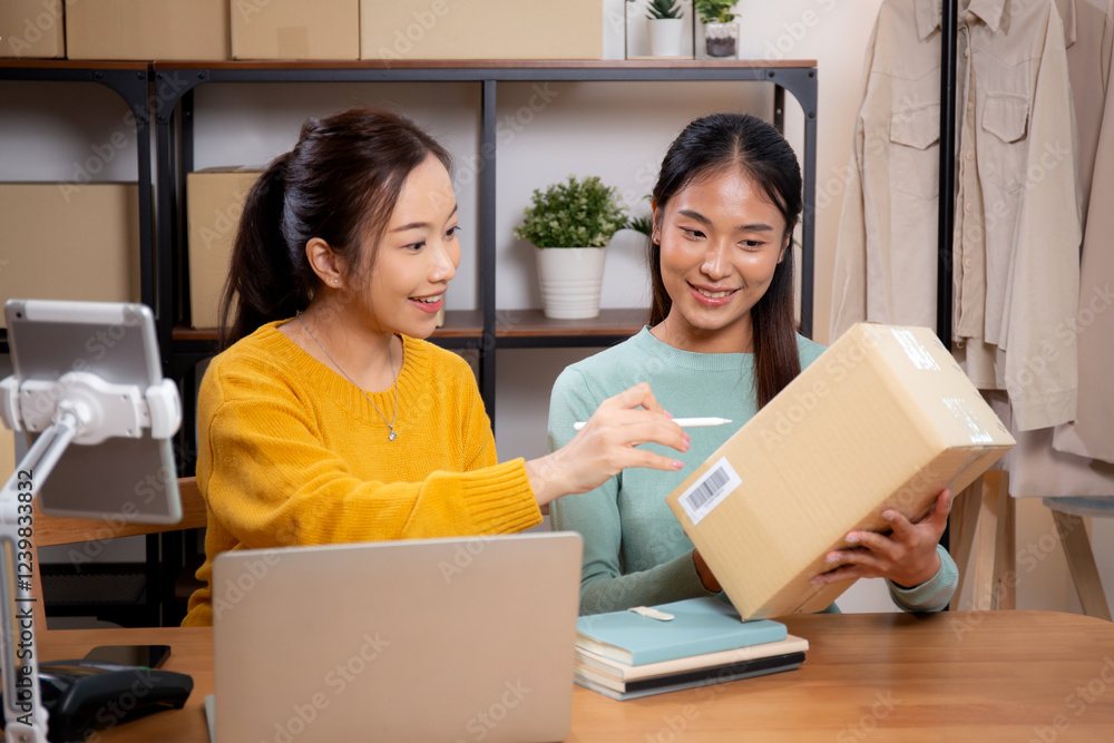 Two young asian woman working while planning online business and checking order with writing on tablet at home, retail with online seller, startup business and cargo, shipping and service. Two young asian woman working while planning online business and checking order with writing on tablet at home, retail with online seller, startup business and cargo, shipping and service.