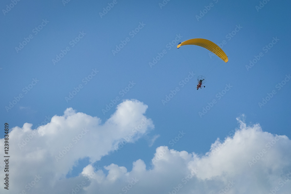 Paramotor flying in blue sky. Extreme leisure sports. Copy space. Paramotor flying in blue sky. Extreme leisure sports. Copy space.