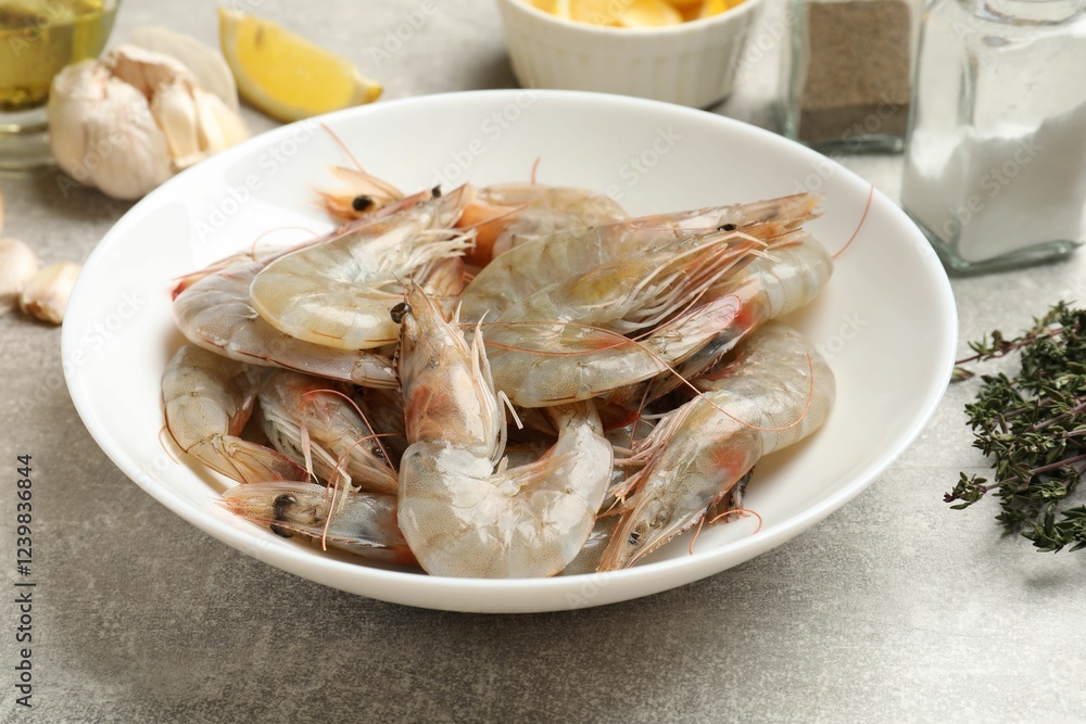 Fresh raw shrimps and spices on grey table, closeup Fresh raw shrimps and spices on grey table, closeup