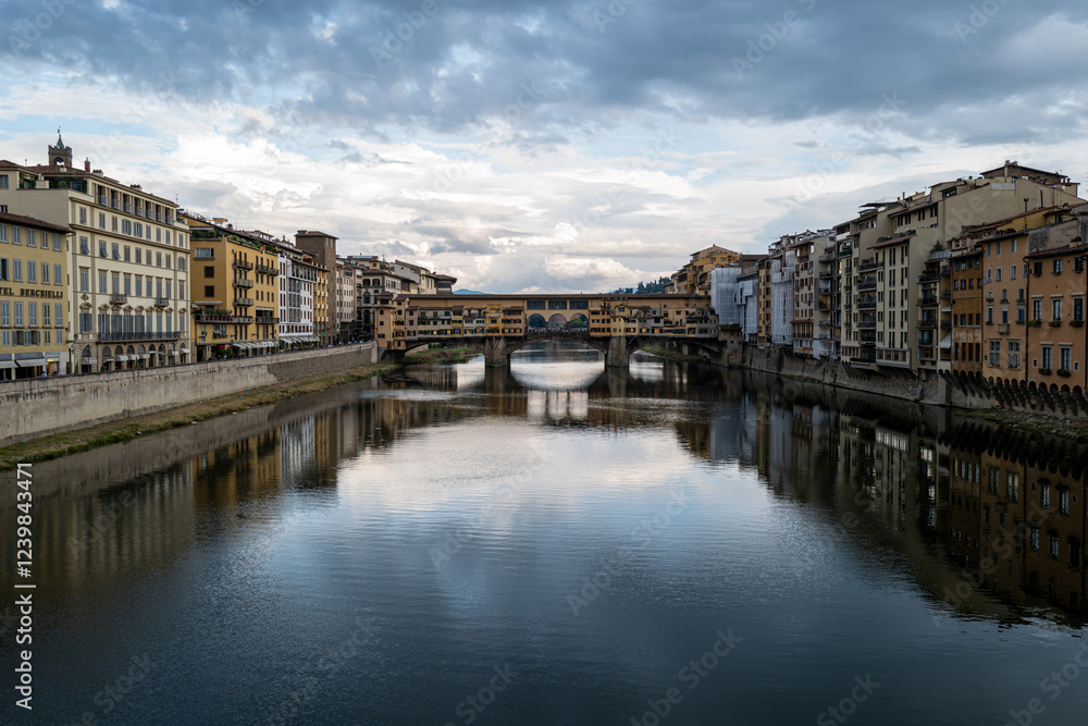 The iconic Ponte Vecchio in Florence, Italy, gracefully spans the Arno River, reflecting the city's charm under a tranquil sky. The iconic Ponte Vecchio in Florence, Italy, gracefully spans the Arno River, reflecting the city's charm under a tranquil sky.