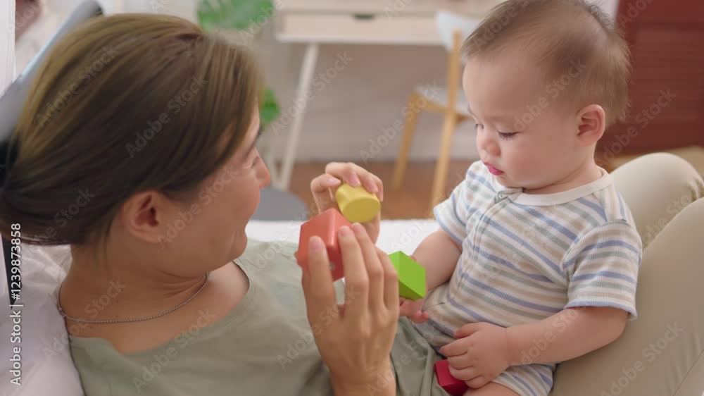 Asian single mother lovingly cares for and raises her baby boy at home. Asian single mother lovingly cares for and raises her baby boy at home.