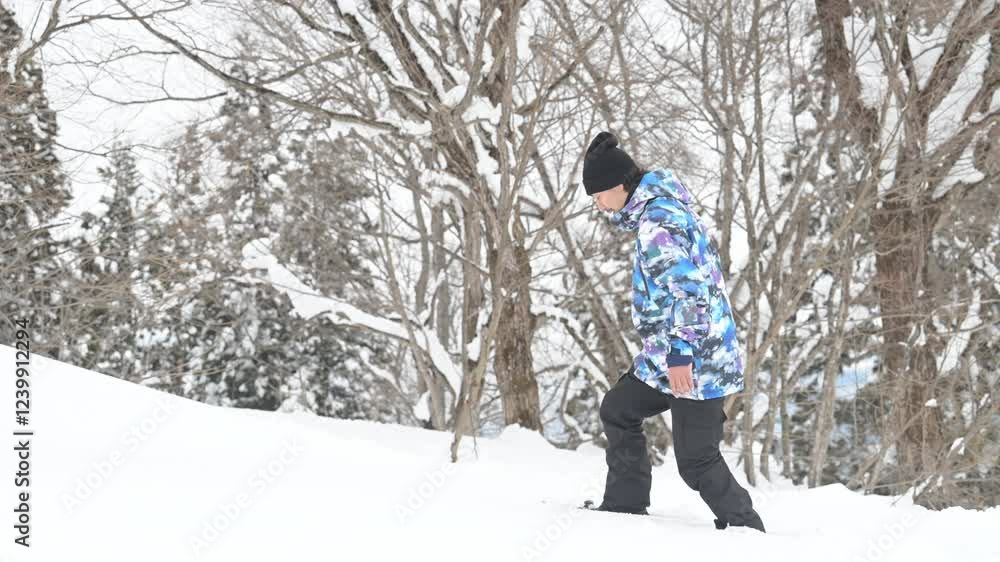 Video of a man snowshoeing in a snowy mountain for winter sports Video of a man snowshoeing in a snowy mountain for winter sports