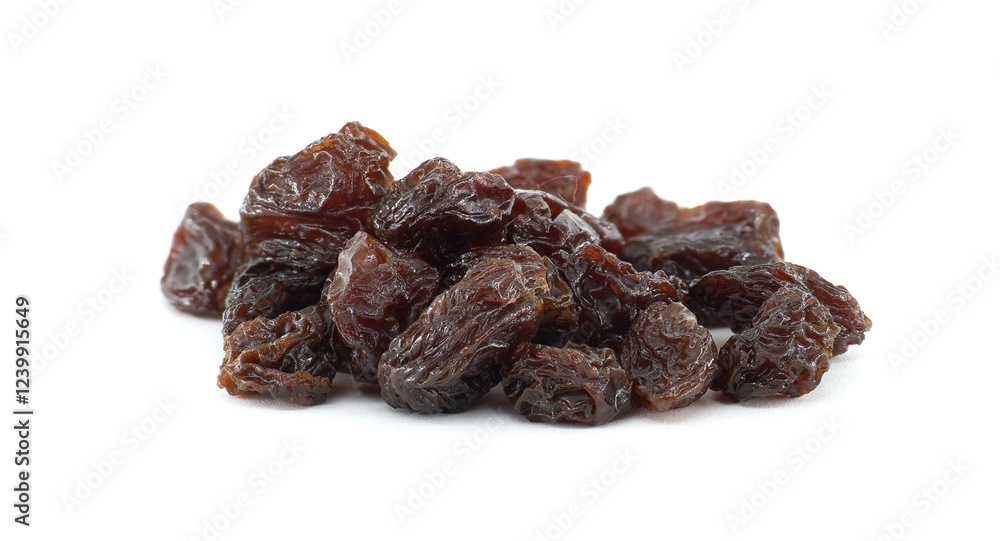 Handful of dark brown raisins, plump and juicy looking captured close-up shot against a white Handful of dark brown raisins, plump and juicy looking captured close-up shot against a white