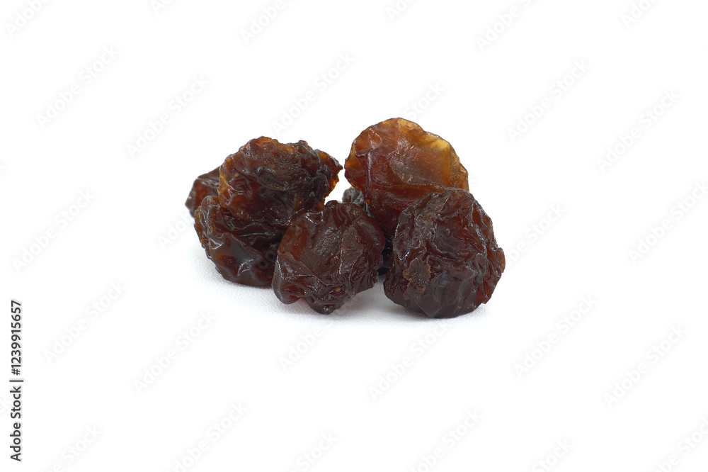 Several dark raisins on a pristine white background; ideal for recipes, baking, or healthy snacking. Several dark raisins on a pristine white background; ideal for recipes, baking, or healthy snacking.
