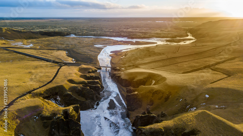 Aerial landscape view of Fjarrgljfur or Fjadrargljufur Canyon with Fjadrar river flow on Iceland. Taken by drone. Nature, travel, winter background, or wallpaper photo