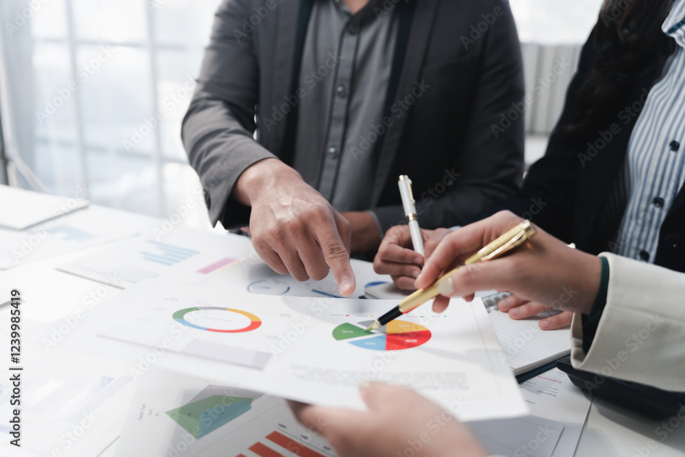 Business people analyzing financial charts and graphs during a meeting Business people analyzing financial charts and graphs during a meeting