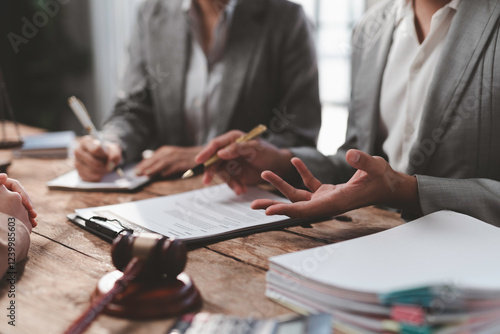 Lawyers discussing contract details during meeting in law firm