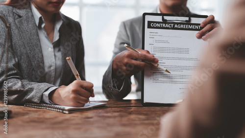 Bild auf Leinwand Business partners reviewing contract agreement terms and conditions