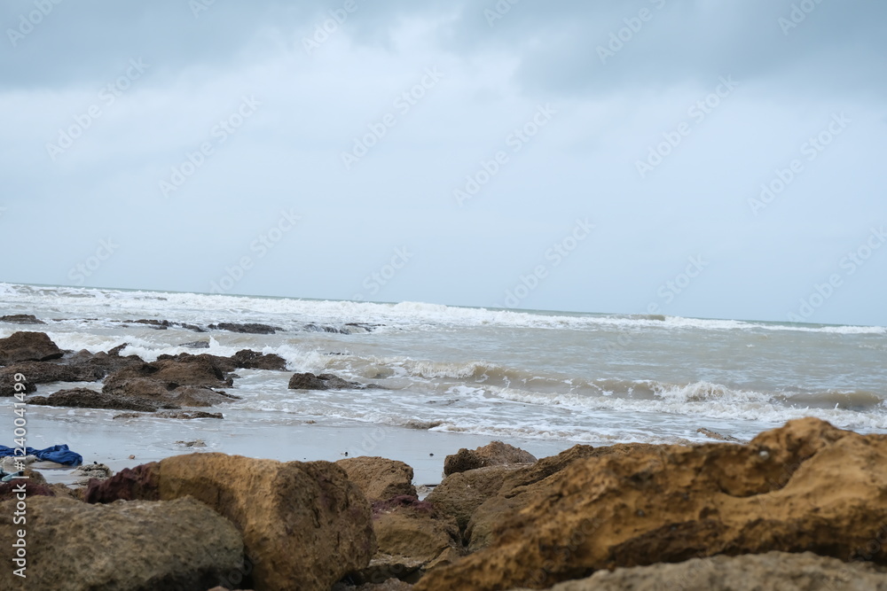 Scenic Rocky Beach with Waves and Cloudy Sky Scenic Rocky Beach with Waves and Cloudy Sky
