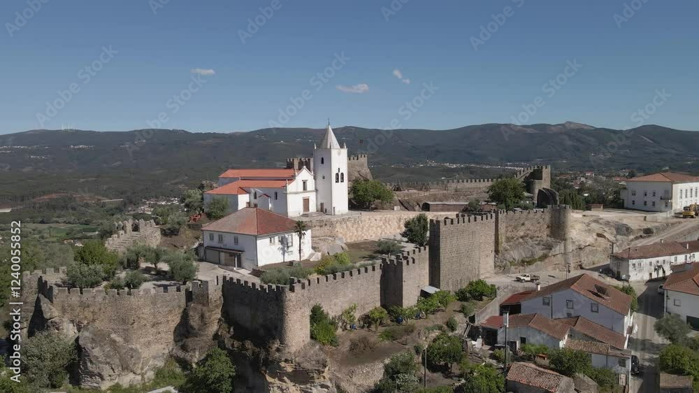 Aerial view of Penela a 1137 municipality of Portugal. Drone rotating to the left showing the contrast of the old castle ruins and the church build inside the fortifications. 4K, 60 fps Aerial view of Penela a 1137 municipality of Portugal. Drone rotating to the left showing the contrast of the old castle ruins and the church build inside the fortifications. 4K, 60 fps
