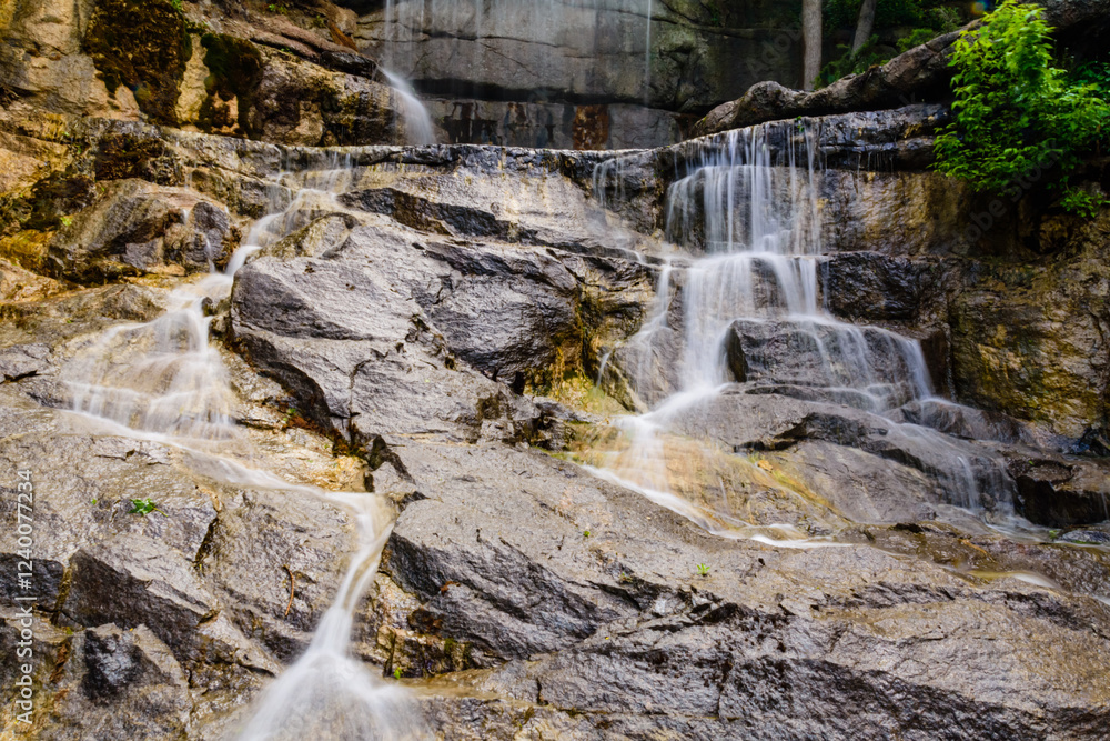 Fototapeta premium Beautiful waterfall on small river in a park